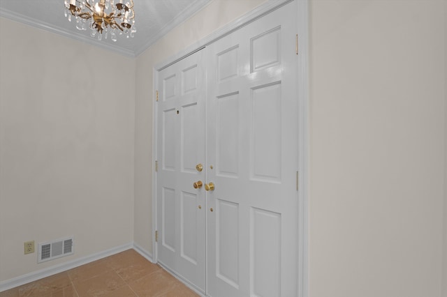 3076 Westwood Rd, Augusta, GA 30909 - entryway featuring a chandelier, ornamental molding, and light tile patterned floors
