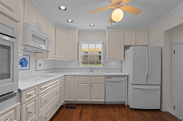 3076 Westwood Rd, Augusta, GA 30909 - kitchen with white appliances, crown molding, dark wood-style floors, white cabinets, and light countertops