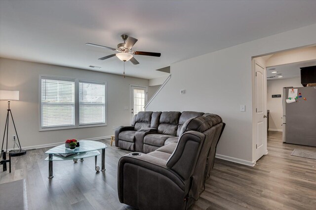 living room with hardwood / wood-style floors and ceiling fan