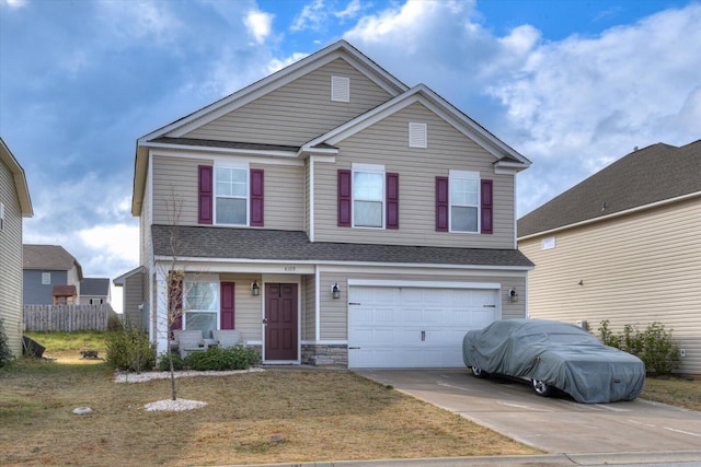 view of property with a front lawn and a garage