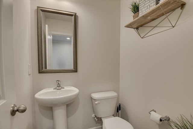 bathroom featuring toilet and sink