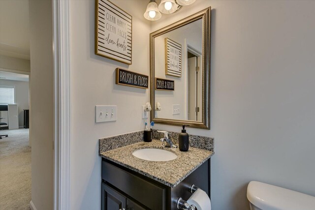 bathroom featuring vanity and toilet