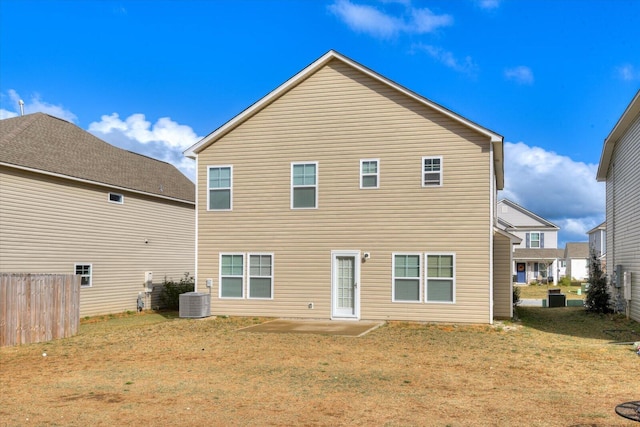 back of property featuring a lawn and cooling unit