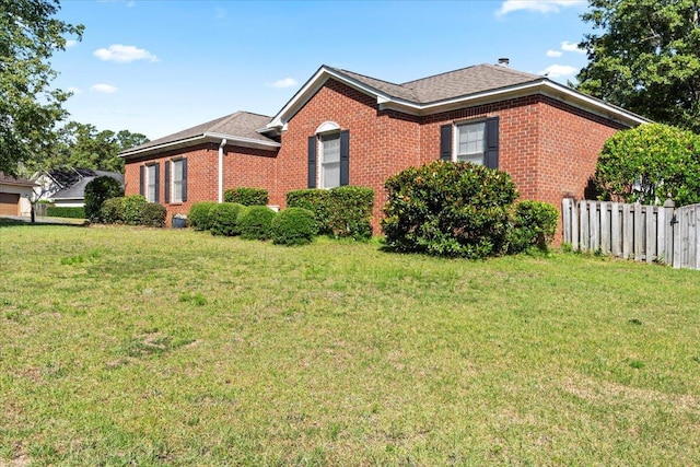 view of side of property with a yard