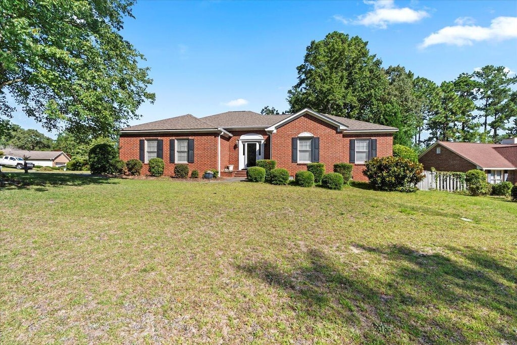 ranch-style house with a front lawn