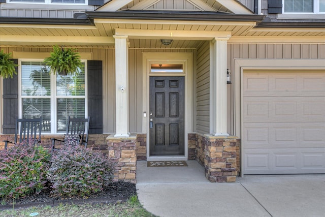 867 Williford Run Dr, Grovetown, GA 30813 - entrance to property featuring stone siding, covered porch, board and batten siding, and a garage