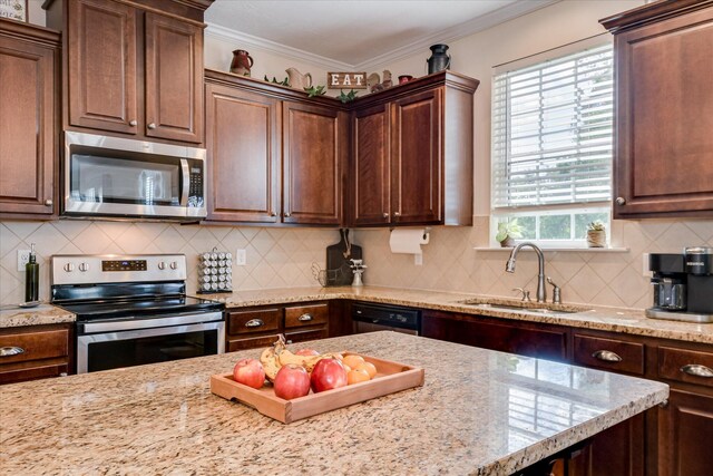 867 Williford Run Dr, Grovetown, GA 30813 - kitchen with stainless steel appliances, a sink, backsplash, light stone countertops, and crown molding