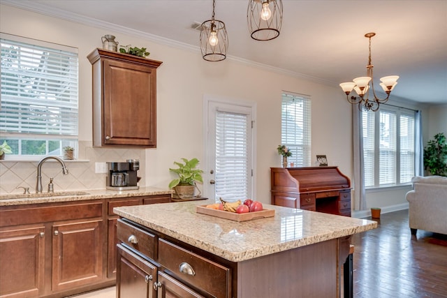 867 Williford Run Dr, Grovetown, GA 30813 - kitchen featuring a sink, plenty of natural light, backsplash, decorative light fixtures, and ornamental molding