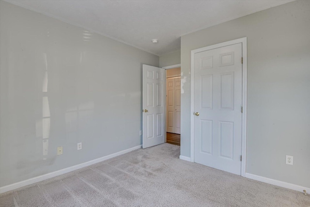 unfurnished bedroom featuring light colored carpet