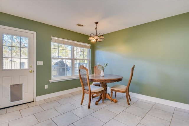 dining room featuring light tile patterned floors and an inviting chandelier