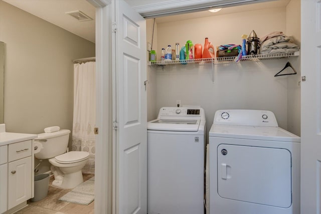 laundry area with washing machine and clothes dryer