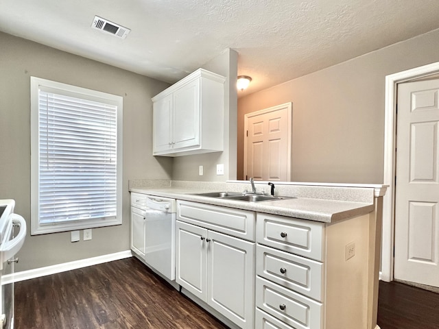 kitchen featuring dark hardwood / wood-style flooring, a textured ceiling, white dishwasher, sink, and white cabinetry