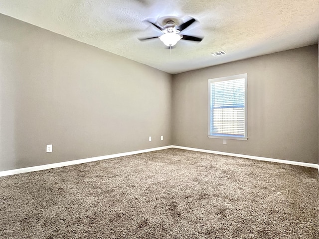 carpeted empty room with a textured ceiling and ceiling fan