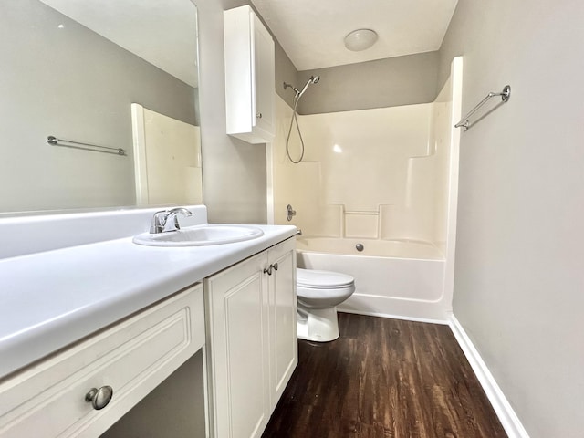 full bathroom featuring washtub / shower combination, hardwood / wood-style floors, vanity, and toilet