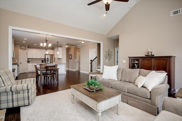 living room with ceiling fan with notable chandelier, dark wood-style flooring, visible vents, and recessed lighting