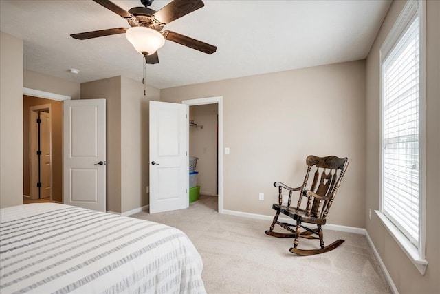 bedroom featuring light colored carpet, ceiling fan, and baseboards