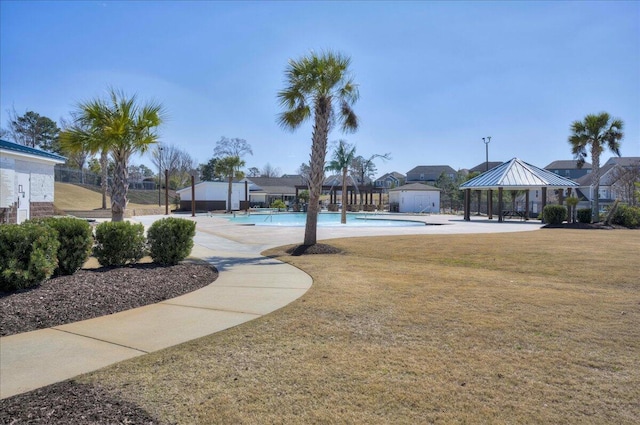 view of home's community featuring a gazebo, a lawn, and a pool