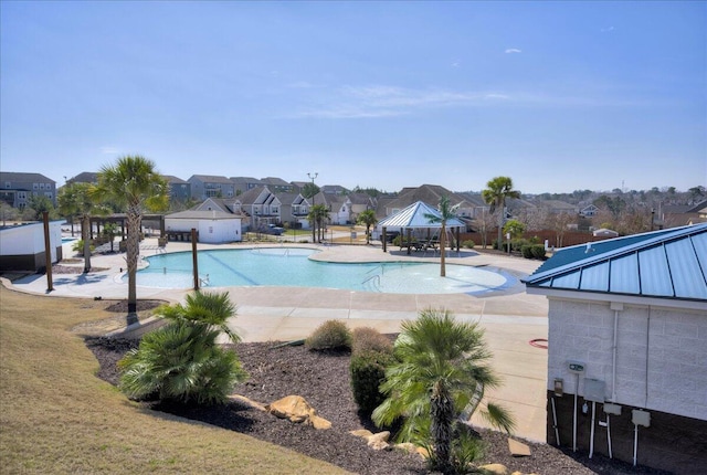 pool with a residential view, a patio, a gazebo, and fence