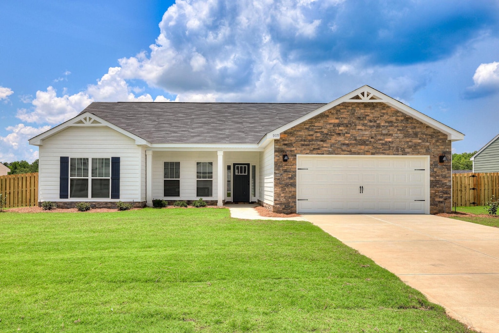 1059 Burlington Dr, Augusta, GA 30909 - view of front facade with concrete driveway, an attached garage, stone siding, and roof with shingles