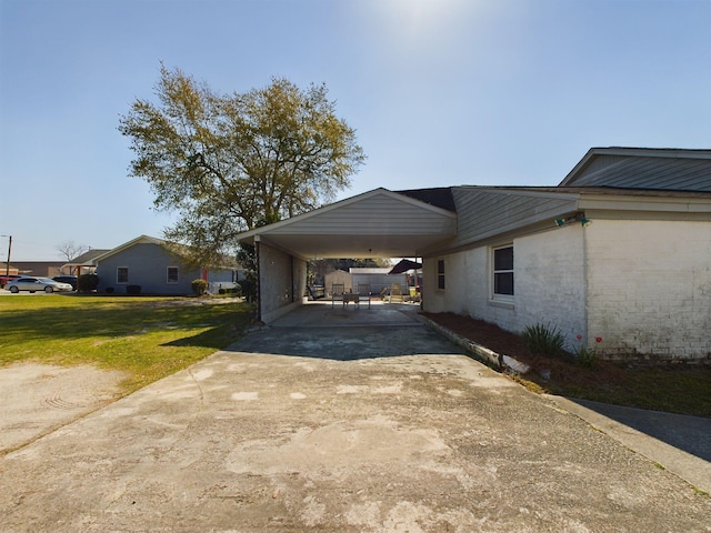 102 Ellis St, Wrens, GA 30833 - view of side of property featuring a lawn and a carport