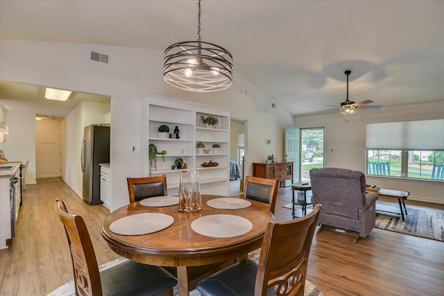 212 Links Pl, Mccormick, SC 29835 - dining area featuring light wood finished floors, healthy amount of natural light, a chandelier, and high vaulted ceiling
