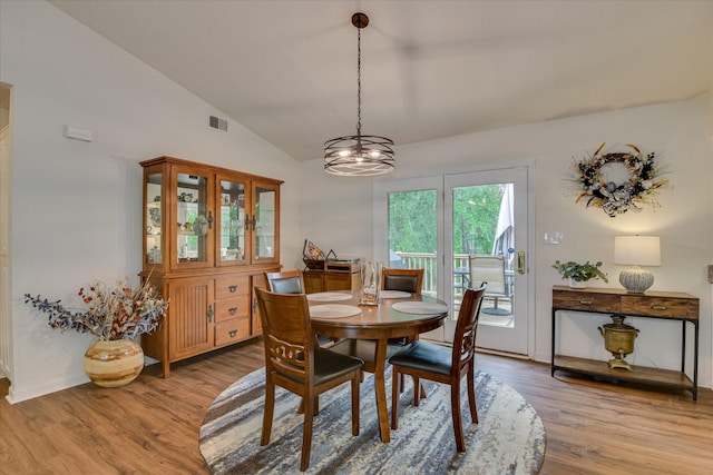 212 Links Pl, Mccormick, SC 29835 - dining area with light wood-style flooring, vaulted ceiling, and a chandelier