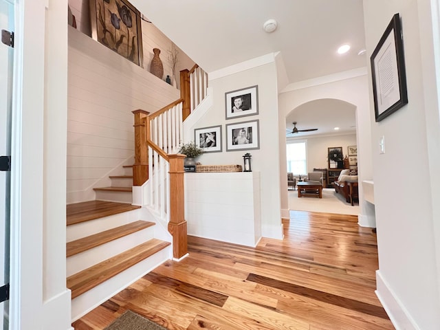 interior space with ceiling fan, ornamental molding, and hardwood / wood-style floors