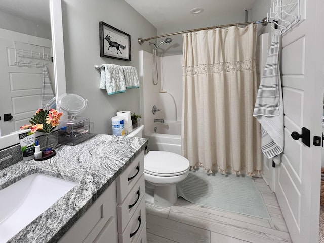 full bathroom featuring shower / tub combo, vanity, and toilet