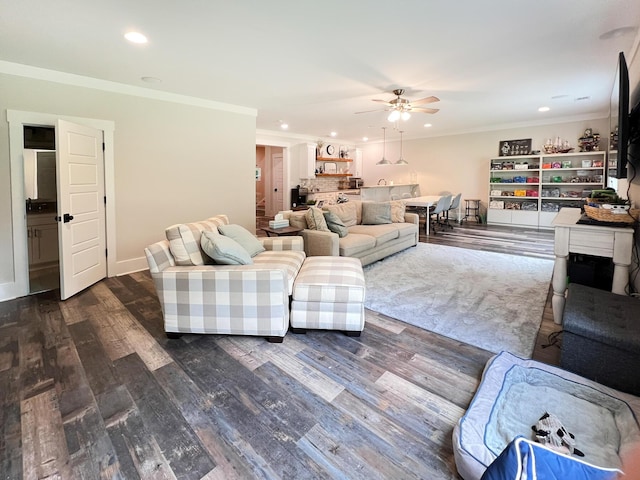 living room with crown molding, ceiling fan, and dark hardwood / wood-style flooring