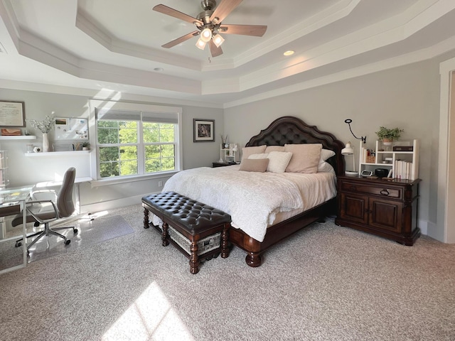 bedroom with ceiling fan, a raised ceiling, and carpet