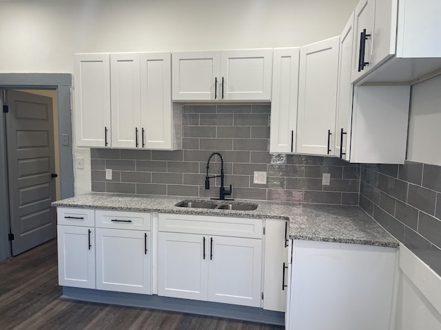 1835 Fenwick St, Augusta, GA 30904 - kitchen with white cabinets, tasteful backsplash, and light stone counters