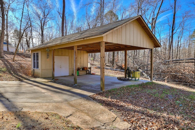 exterior space featuring a carport and an outdoor structure