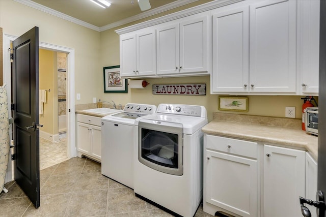 washroom with washing machine and dryer, cabinets, sink, ornamental molding, and light tile patterned flooring