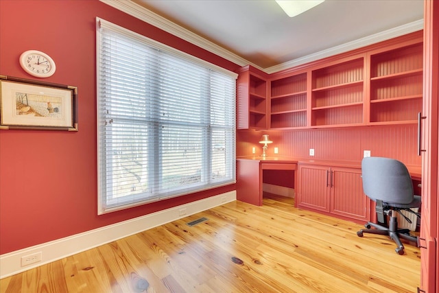 unfurnished office featuring crown molding and light wood-type flooring