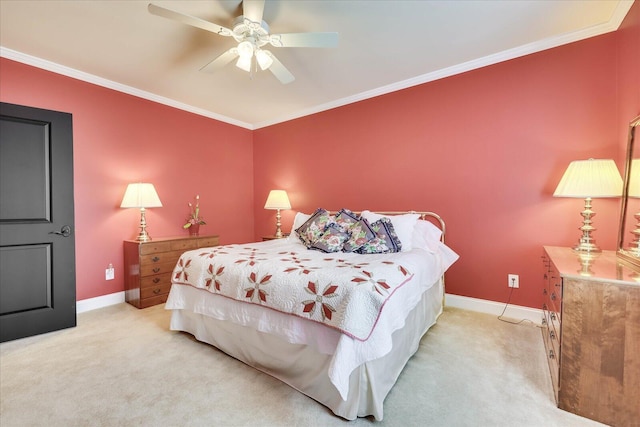 carpeted bedroom featuring ceiling fan and crown molding