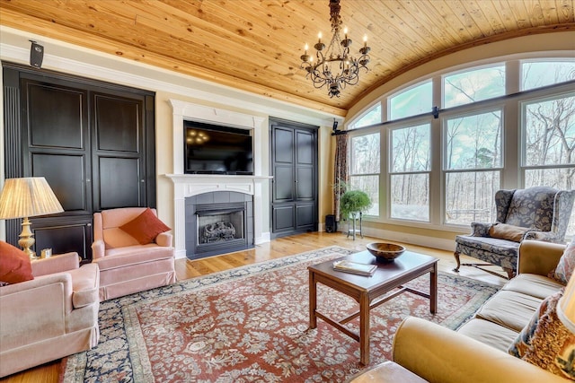 living room with light wood-type flooring, an inviting chandelier, vaulted ceiling, wooden ceiling, and a tiled fireplace