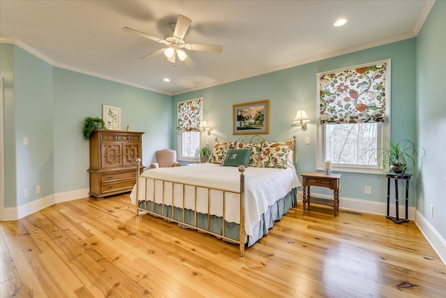 bedroom with ceiling fan, crown molding, and multiple windows