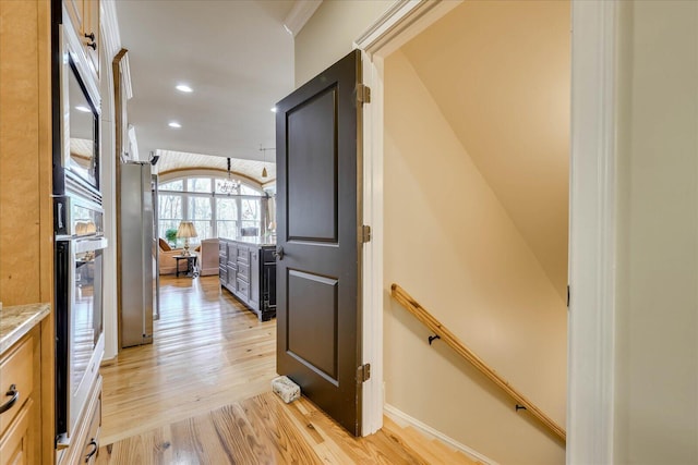 hallway with light hardwood / wood-style floors