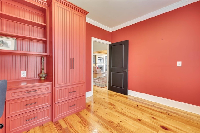 interior space featuring light hardwood / wood-style floors and crown molding