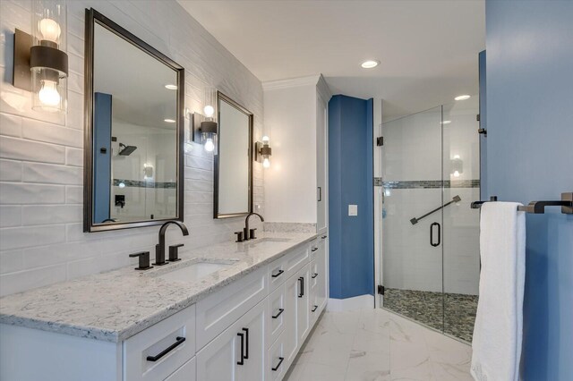 bathroom featuring vanity, backsplash, and a shower with door