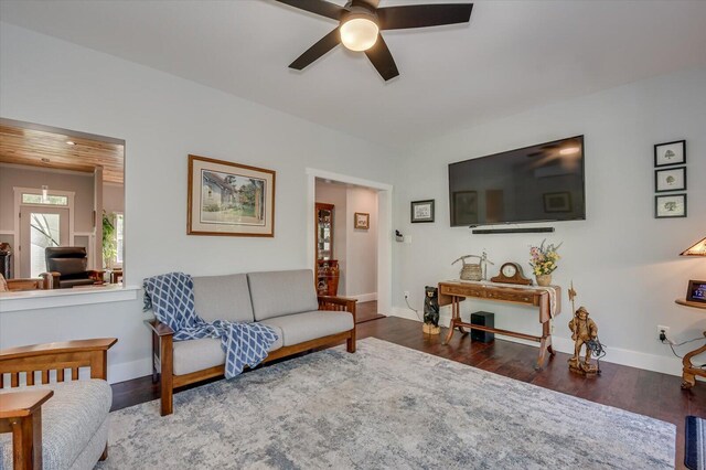 living room with ceiling fan and dark hardwood / wood-style floors