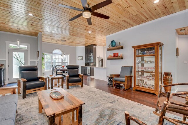 living room with hardwood / wood-style flooring, ceiling fan, wooden ceiling, and ornamental molding