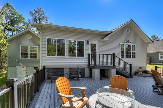 rear view of house with a wooden deck