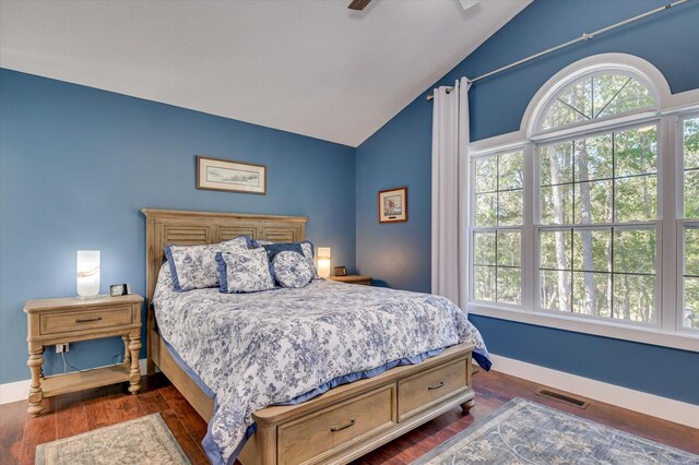 bedroom featuring dark hardwood / wood-style floors, ceiling fan, and lofted ceiling