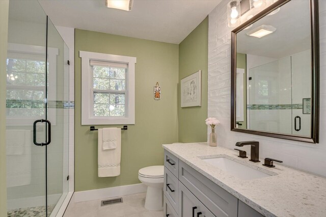 bathroom with decorative backsplash, tile patterned floors, vanity, toilet, and a shower with shower door