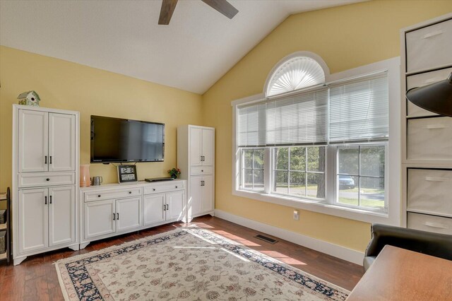 living room featuring vaulted ceiling, ceiling fan, and dark wood-type flooring