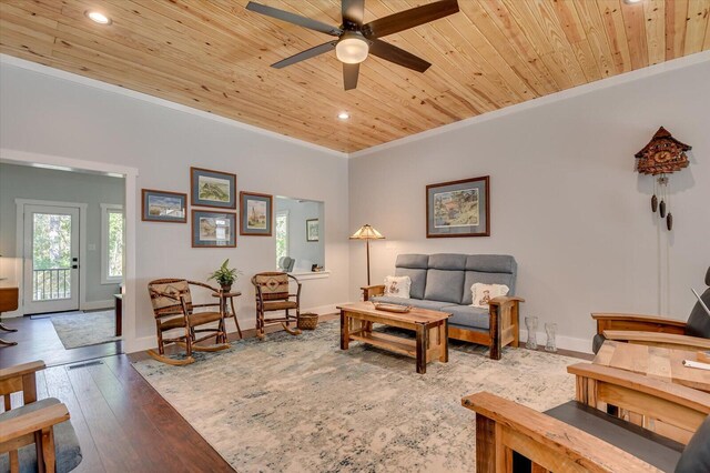 living room featuring ceiling fan, light hardwood / wood-style flooring, wooden ceiling, and ornamental molding