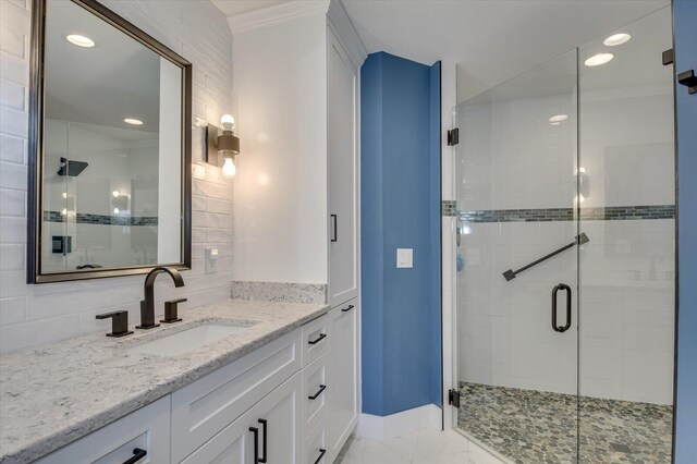 bathroom featuring vanity and an enclosed shower