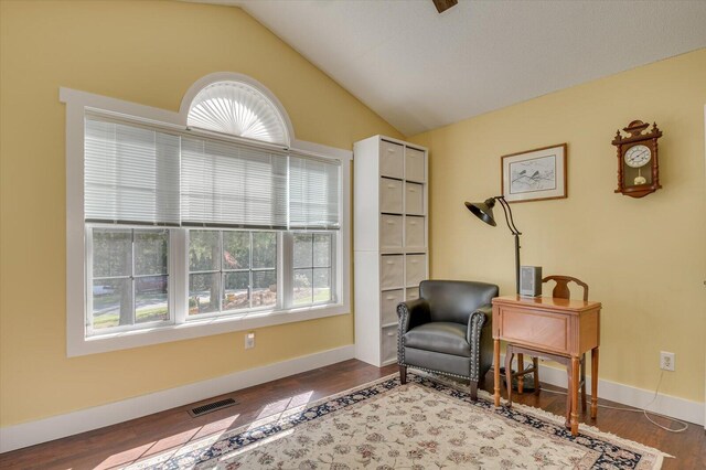 living area featuring hardwood / wood-style floors and vaulted ceiling