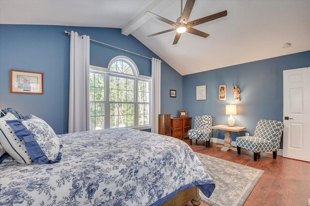 bedroom featuring wood-type flooring, vaulted ceiling with beams, and ceiling fan